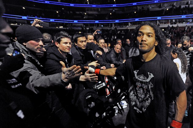 Benson Henderson celebrates with fans after defeating Josh Thomson during the main event of the UFC mixed martial arts match in Chicago, Saturday, Jan., 25, 2014. (AP Photo/Paul Beaty)