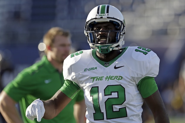 Marshall quarterback Rakeem Cato (12)  during pre game practic of an NCAA college football game against Florida International, Saturday, Oct. 18, 2014, in Miami. (AP Photo/Alan Diaz)