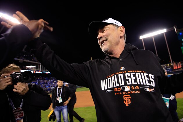 KANSAS CITY, MO - OCTOBER 29:  Manager Bruce Bochy #15 of the San Francisco Giants celebrates on the field after defeating the Kansas City Royals 3-2 to win Game Seven of the 2014 World Series at Kauffman Stadium on October 29, 2014 in Kansas City, Missouri.  (Photo by Jamie Squire/Getty Images)