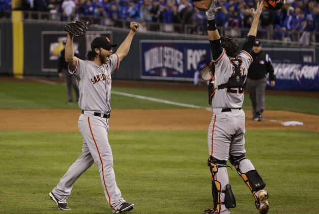 San Francisco Giants pitcher Madison Bumgarner, left, and Buster Posey celebrate after winning 3-2 to win the series over Kansas City Royals after Game 7 of baseball's World Series Wednesday, Oct. 29, 2014, in Kansas City, Mo. (AP Photo/Matt Slocum)