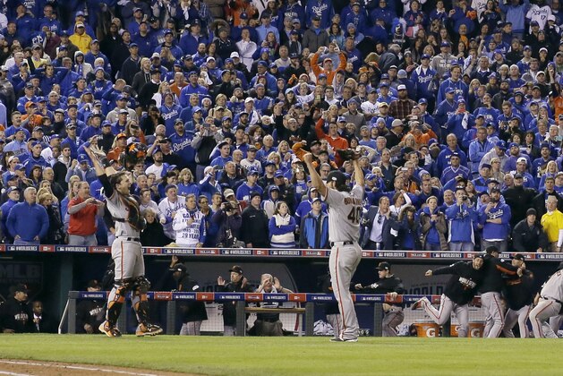 San Francisco Giants catcher Buster Posey (28) and pitcher Madison Bumgarner (40) celebrate after Game 7 of baseball's World Series Wednesday, Oct. 29, 2014, in Kansas City, Mo. The Giants won 3-2 to win the series. (AP Photo/David J. Phillip)