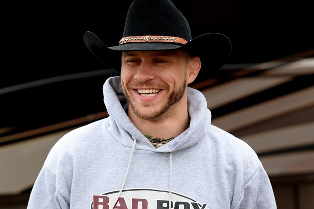 DAYTONA BEACH, FL - FEBRUARY 22:  Donald 'Cowboy' Cerrone looks on as he presents NASCAR driver Kevin Harvick (not pictured) with an UFC belt at Daytona International Speedway on February 22, 2014 in Daytona Beach, Florida.  (Photo by Jared C. Tilton/Getty Images)