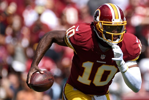 LANDOVER, MD - SEPTEMBER 14: Quarterback Robert Griffin III #10 of the Washington Redskins rushes against the Jacksonville Jaguars in the first half at FedExField on September 14, 2014 in Landover, Maryland. The Washington Redskins won, 41-10. (Photo by Patrick Smith/Getty Images)