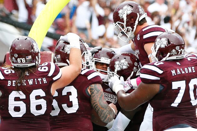STARKVILLE, MS - OCTOBER 11:  Dak Prescott #15 of the Mississippi State Bulldogs celebrates with teammates after scoring a touchdown against the Auburn Tigers at Davis Wade Stadium on October 11, 2014 in Starkville, Mississippi.  (Photo by Kevin C. Cox/Getty Images)