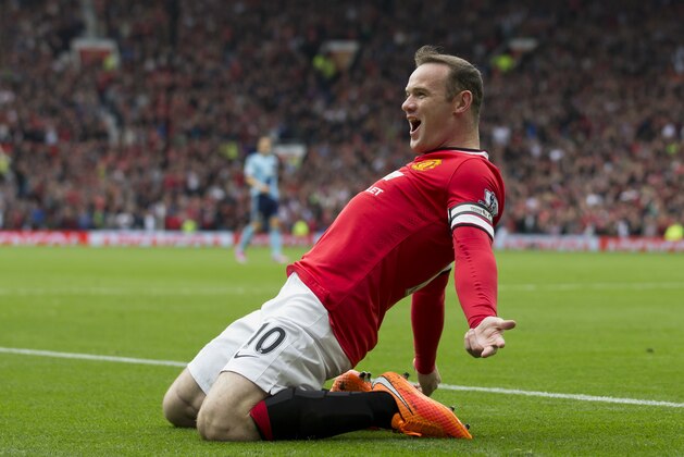 Manchester United's Wayne Rooney celebrates after scoring against West Ham United during their English Premier League soccer match at Old Trafford Stadium, Manchester, England, Saturday Sept. 27, 2014. (AP Photo/Jon Super)