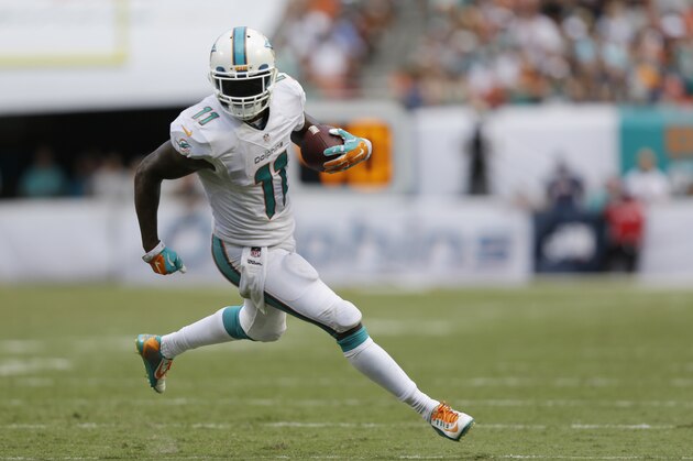 Miami Dolphins wide receiver Mike Wallace (11) runs for a touchdown during the second half of an NFL football game against the New England Patriots, in Miami Gardens, Fla., Sunday Sept. 7, 2014. (AP Photo/Wilfredo Lee)