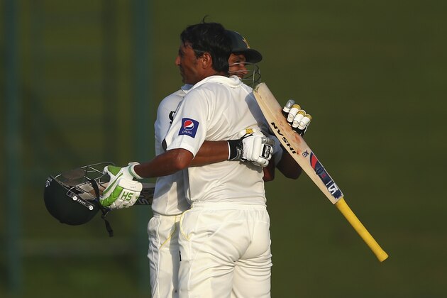 ABU DHABI, UNITED ARAB EMIRATES - OCTOBER 30:  Younis Khan of Pakistan is congratulated by Azhar Ali of Pakistan after reaching his century during Day One of the Second Test at Sheikh Zayed Stadium on October 30, 2014 in Abu Dhabi, United Arab Emirates.  (Photo by Ryan Pierse/Getty Images)