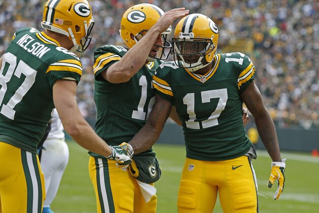 Green Bay Packers wide receiver Davante Adams (17) is congratulated by quarterback Aaron Rodgers (12) and wide receiver Jordy Nelson (87) after scoring a touchdown against the Carolina Panthers during an NFL football game Sunday Oct. 19, 2014, in Green Bay, Wis. (AP Photo/Matt Ludtke)