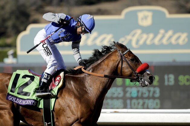 Jockey Rafael Bejarano celebrates after Goldencents wins the Breeders' Cup Dirt Mile horse race at Santa Anita Park Friday, Nov. 1, 2013, in Arcadia, Calif. (AP Photo/Jae C. Hong)