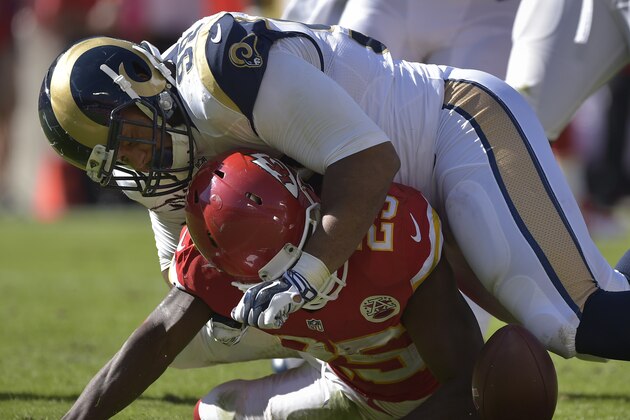 Kansas City Chiefs running back Jamaal Charles (25) fumbles while being tackled by St. Louis Rams defensive tackle Aaron Donald (99) during an NFL football game Sunday, Oct. 26, 2014, in Kansas City, Mo. (AP Photo/Reed Hoffmann)