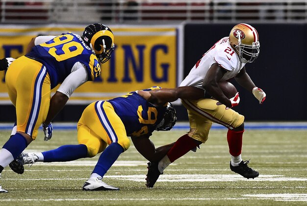 Oct 13, 2014; St. Louis, MO, USA; St. Louis Rams defensive end Robert Quinn (94) tackles San Francisco 49ers running back Frank Gore (21) during the second half at the Edward Jones Dome. The San Francisco 49ers defeat the St. Louis Rams 31-17. Mandatory Credit: Jasen Vinlove-USA TODAY Sports
