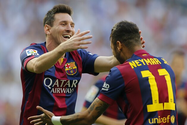 Barcelona's Lionel Messi, left celebrates with teammate Neymar after scoring during a Spanish La Liga soccer match between Real Madrid and Barcelona at the Santiago Bernabeu stadium in Madrid, Spain, Saturday Oct. 25, 2014. (AP Photo/Paul White)