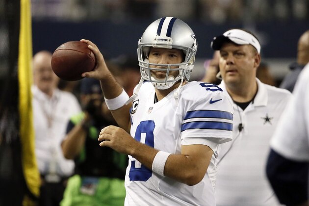 Dallas Cowboys quarterback Tony Romo throws on the sideline after being helped off the field following a hit by Washington Redskins inside linebacker Keenan Robinson during the second half of an NFL football game, Monday, Oct. 27, 2014, in Arlington, Texas. (AP Photo/Brandon Wade)