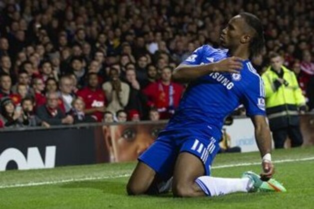 Chelsea's Didier Drogba celebrates after scoring against Manchester United during the English Premier League soccer match between Manchester United and Chelsea at Old Trafford Stadium, Manchester, England, Sunday Oct. 26, 2014. (AP Photo/Jon Super)