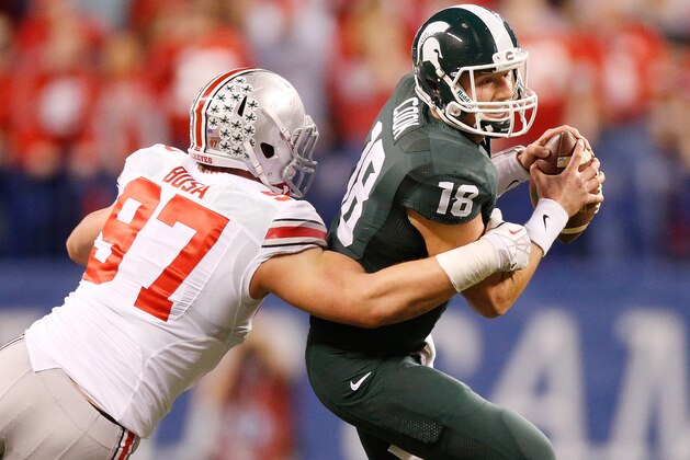 INDIANAPOLIS, IN - DECEMBER 07:  Joey Bosa #97 of the Ohio State Buckeyes sacks Connor Cook #18 of the Michigan State Spartans in the first quarter during the Big 10 Conference Championship Game at Lucas Oil Stadium on December 7, 2013 in Indianapolis, Indiana.  (Photo by Gregory Shamus/Getty Images)