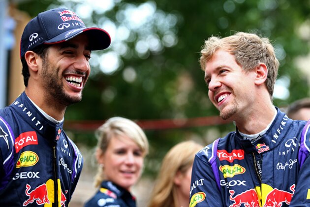 AUSTIN, TX - OCTOBER 29:  Daniel Ricciardo of Australia and Infiniti Red Bull Racing and Sebastian Vettel of Germany and Infiniti Red Bull Racing smile as they talk before driving along North Congress Avenue during previews ahead of the United States Formula One Grand Prix on the streets of Austin on October 29, 2014 in Austin, United States.  (Photo by Mark Thompson/Getty Images)
