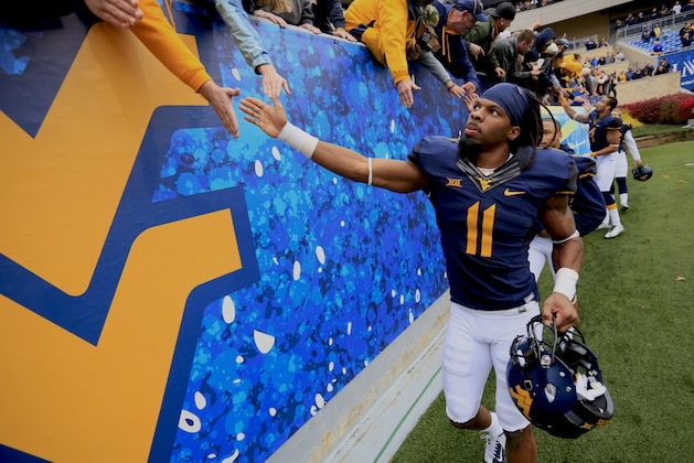 West Virginia's Kevin White (11) celebrates with fans following their 41-27 win over Baylor during during an NCAA college football game in Morgantown, W.Va., Saturday, Oct. 18, 2014. (AP Photo/Chris Jackson)