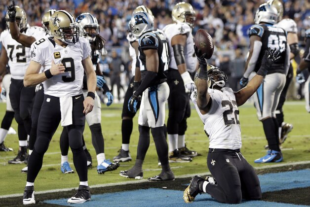 New Orleans Saints' Mark Ingram (22) celebrates his touchdown against the Carolina Panthers with Drew Brees (9) in the first half of an NFL football game in Charlotte, N.C., Thursday, Oct. 30, 2014. (AP Photo/Chuck Burton)