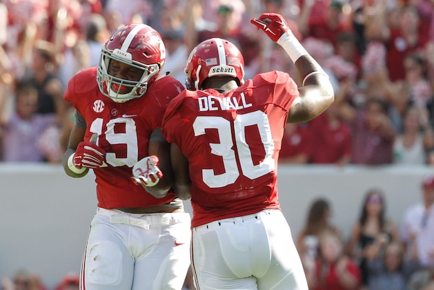 Sep 20, 2014; Tuscaloosa, AL, USA; Alabama Crimson Tide linebacker Reggie Ragland (19) and Alabama Crimson Tide linebacker Denzel Devall (30) celebrate after a play during the game against the Florida Gators at Bryant-Denny Stadium. Mandatory Credit: Marvin Gentry-USA TODAY Sports