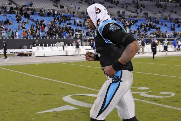 Carolina Panthers' Cam Newton (1) runs off the field after an NFL football game against the New Orleans Saints in Charlotte, N.C., Thursday, Oct. 30, 2014. The Saints won 28-10. (AP Photo/Mike McCarn)