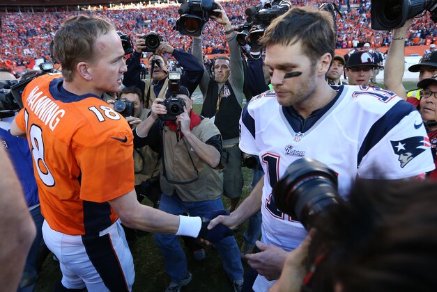 Jan 19, 2014; Denver, CO, USA; Denver Broncos quarterback Peyton Manning (18) meets with New England Patriots quarterback Tom Brady (12) after the 2013 AFC Championship game at Sports Authority Field at Mile High. Mandatory Credit: Matthew Emmons-USA TODAY Sports