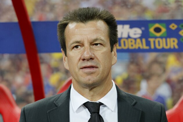 Brazil football team coach Dunga watches his players before his teams international friendly soccer match against Japan in Singapore, Tuesday, Oct. 14, 2014. (AP Photo/Wong Maye-E)