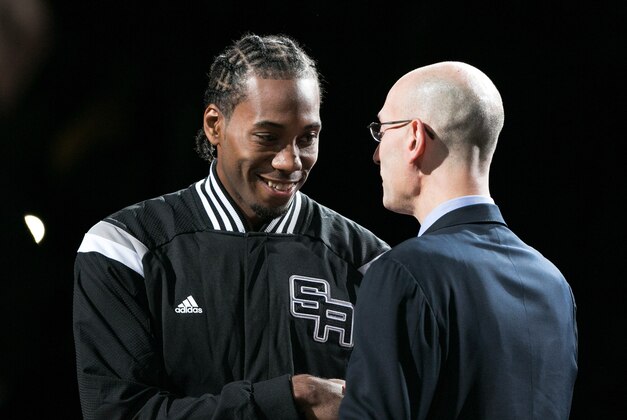 Oct 28, 2014; San Antonio, TX, USA; San Antonio Spurs small forward Kawhi Leonard (2) hugs NBA commissioner Adam Silver during a ceremony before the game against the Dallas Mavericks at AT&T Center. Mandatory Credit: Soobum Im-USA TODAY Sports