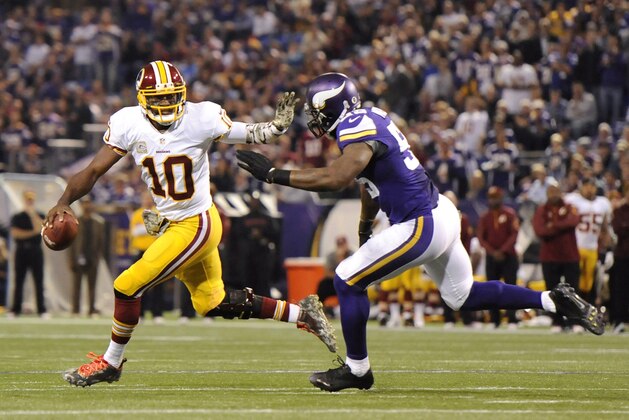 MINNEAPOLIS, MN - NOVEMBER 7: Robert Griffin III #10 of the Washington Redskins scrambles with the ball away from Marvin Mitchell #55 of the Minnesota Vikings during the first quarter of the game on November 7, 2013 at Mall of America Field at the Hubert H. Humphrey Metrodome in Minneapolis, Minnesota. (Photo by Hannah Foslien/Getty Images)