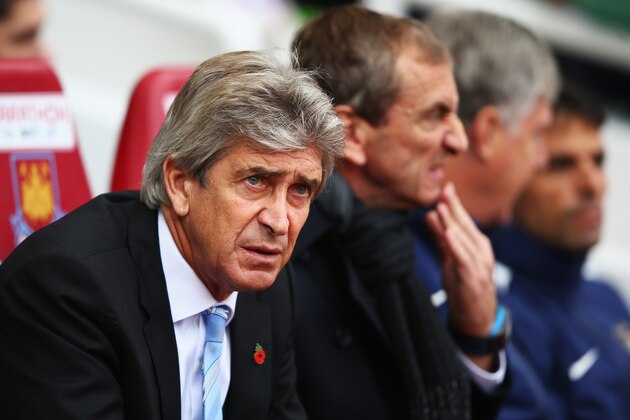 LONDON, ENGLAND - OCTOBER 25:  Manuel Pellegrini, manager of Manchester City looks on with assistant Ruben Cousillas during the Barclays Premier League match between West Ham United and Manchester City at Boleyn Ground on October 25, 2014 in London, England.  (Photo by Ian Walton/Getty Images)