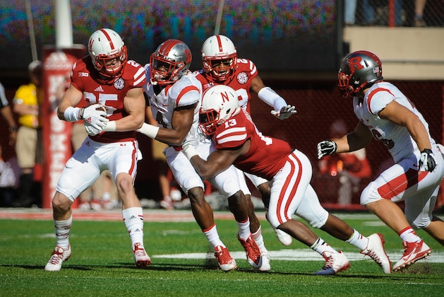 LINCOLN, NE - OCTOBER 25: Defensive back Nate Gerry #25 of the Nebraska Cornhuskers intercepts a ball in tended for wide receiver Leonte Carroo #4 of the Rutgers Scarlet Knights in action during the game at Memorial Stadium on October 25, 2014 in Lincoln, Nebraska. Nebraska defeated Rutgers 42-24. (Photo by Eric Francis/Getty Images)