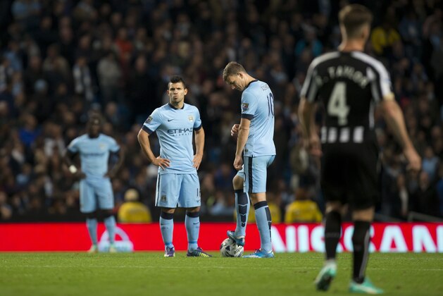 Manchester City's Edin Dzeko, centre right, and Sergio Aguero, centre left, wait for play to restart after Newcastle's second goal during the English League Cup soccer match between Manchester City and Newcastle at the Etihad Stadium, Manchester, England, Wednesday Oct. 29, 2014.  Newcastle won the game 2-0. (AP Photo/Jon Super)