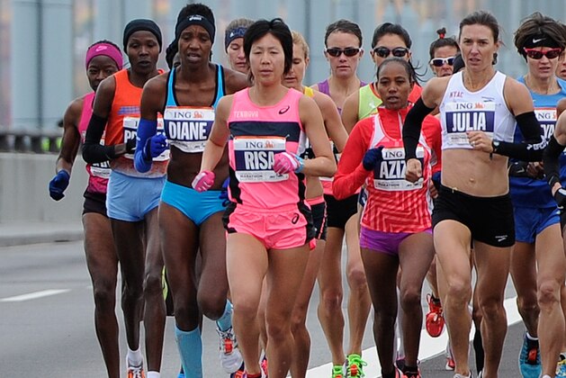 NEW YORK, NY - NOVEMBER 03: Diane Nukuri-Johnson of the United States, Risa Shigetomo of Japan, Aziza Aliyu and Julia Mallon of the United States cross the Verrazano-Narrows Bridge with the other competitors in the Professional Women's division at the start of the ING New York City Marathon on November 3, 2013 in the Brooklyn borough of New York City.  (Photo by Maddie Meyer/Getty Images)
