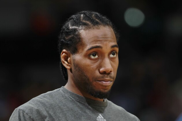 San Antonio Spurs forward Kawhi Leonard warms up before facing the Denver Nuggets in the third quarter of the Spurs' 133-102 victory in an NBA basketball game in Denver on Friday, March 28, 2014. (AP Photo/David Zalubowski)