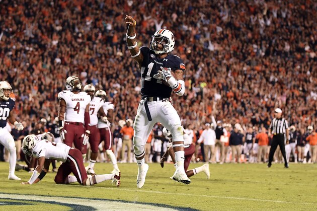 AUBURN, AL - OCTOBER 25:  Nick Marshall #14 of the Auburn Tigers scores a touchdown during the fourth quarter of a game against the South Carolina Gamecocks at Jordan Hare Stadium on October 25, 2014 in Auburn, Alabama.  (Photo by Stacy Revere/Getty Images)
