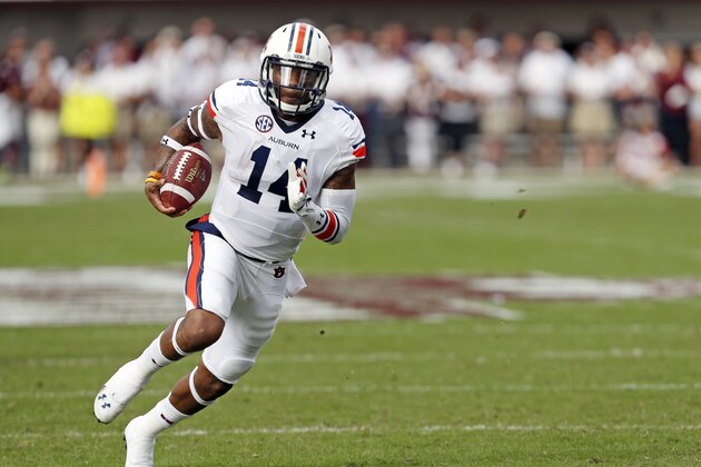 Auburn quarterback Nick Marshall (14) runs upfield for a gain against Mississippi State in the first half of their NCAA college football game in Starkville, Miss., Saturday, Oct 11, 2014. No. 3 Mississippi State beat No. 2 Auburn 38-23. (AP Photo/Rogelio V. Solis)