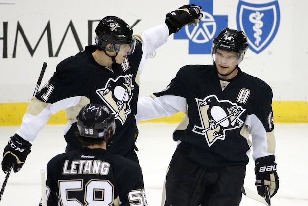 Pittsburgh Penguins' Chris Kunitz (14) celebrates his goal with Evgeni Malkin (71), and Kris Letang (58) in the first period of an NHL hockey game against the Los Angeles Kings in Pittsburgh, Thursday, Oct. 30, 2014. (AP Photo/Gene J. Puskar)