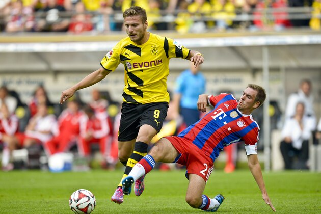 Dortmund's Ciro Immobile, left,  and Munich's Philipp Lahm vie for the ball with during the German soccer Super Cup match between Borussia Dortmund and Bayern Munich in Dortmund, Germany, Wednesday, Aug. 13, 2014. (AP Photo/Sascha Schuermann)
