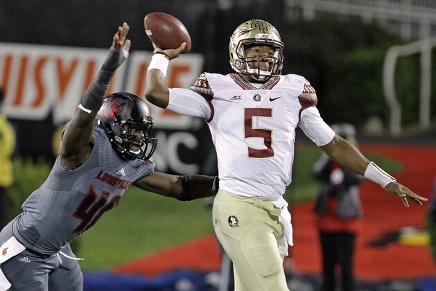 Florida State quarterback Jameis Winston (5) gets off a pass despite the efforts of Louisville defensive end Delontrez Mount (48) in the second half of their NCAA college football game in Louisville, Ky., Thursday, Oct. 30, 2014. Winston led No. 2 Florida State to a 42-31 come-from-behind victory over Louisville. (AP Photo/Garry Jones)