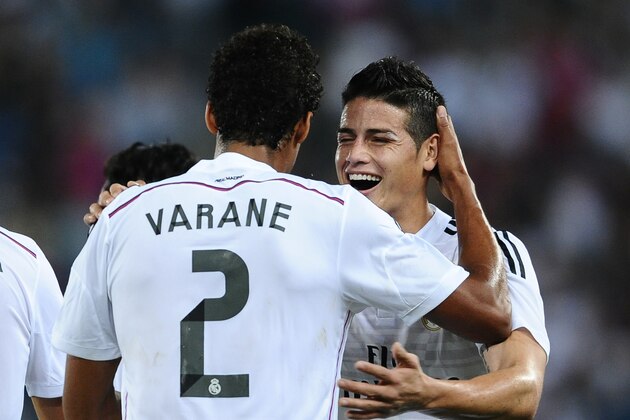Real Madrid's Raphael Varane, left, reacts after scoring his second goal with his teammate James Rodriguez against Cornella during a Copa del Rey soccer match in Cornella Llobregat, Spain, Wednesday, Oct. 29, 2014. (AP Photo/Manu Fernandez)