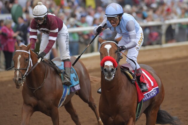 Rafael Bejarano,right, celebrates after riding Goldencents to victory past jockey Rosie Napravnik on Tapiture in the Breeders' Cup Dirt Mile horse race at Santa Anita on Friday, Oct. 31, 2014, in Arcadia, Calif. (AP Photo/Mark J. Terrill)