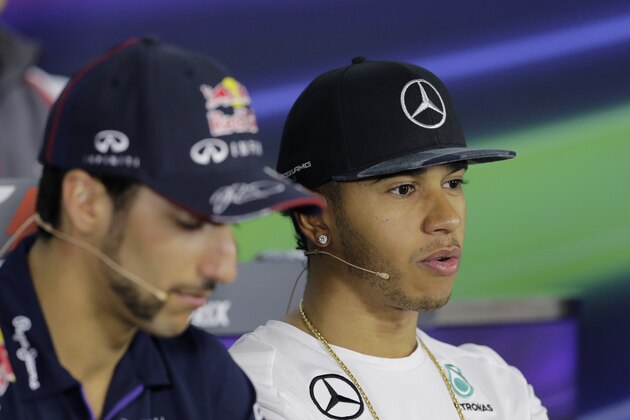 Red Bull driver Daniel Ricciardo, of Australia, left, and Mercedes driver Lewis Hamilton, of Britain, right, talk during a news conference for the Formula One's U.S. Grand Prix at the Circuit of the Americas, Thursday, Oct. 30, 2014, in Austin, Texas. (AP Photo/Eric Gay)