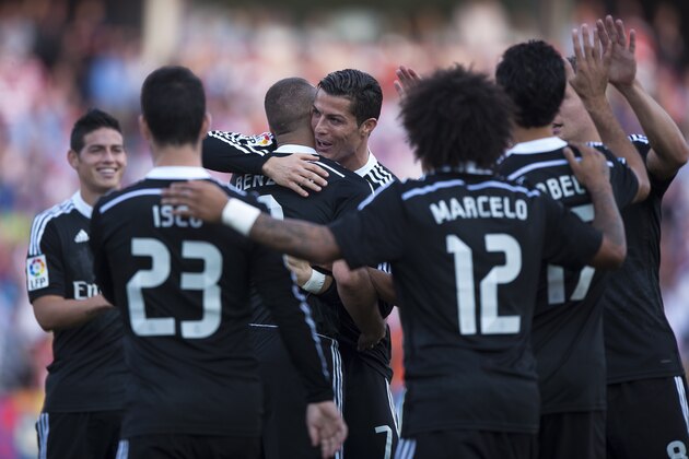 Real Madrid's Karim Benzema from France, center back, celebrates his goal with team mates Cristiano Ronaldo from Portugal, during a Spanish La Liga soccer match between Granada and Real Madrid at the Nuevo Los Carmenes stadium in Granada, Spain Saturday Nov. 1, 2014. (AP Photo/Daniel Tejedor)