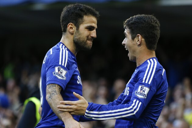 Chelsea's Oscar, right, celebrates scoring a goal with team member Cesc Fabregas during the English Premier League soccer match between Chelsea and Queens Park Rangers at Stamford Bridge Stadium in London, Saturday, Nov. 1, 2014. (AP Photo/Kirsty Wigglesworth)
