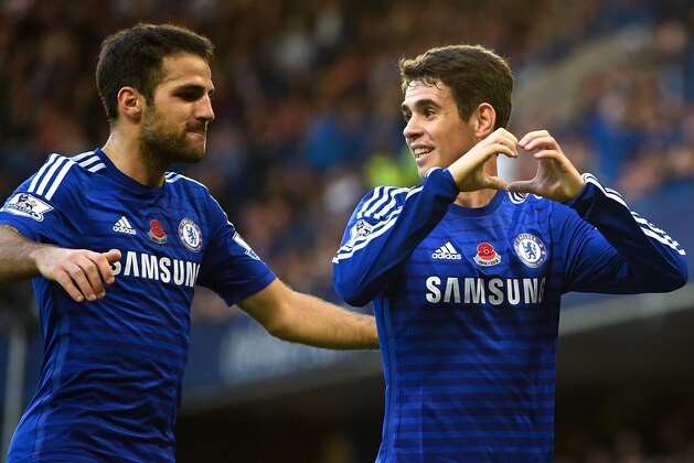LONDON, ENGLAND - NOVEMBER 01:  Oscar of Chelsea celebrates his goal with Cesc Fabregas during the Barclays Premier League match between Chelsea and Queens Park Rangers at Stamford Bridge on November 1, 2014 in London, England.  (Photo by Mike Hewitt/Getty Images)
