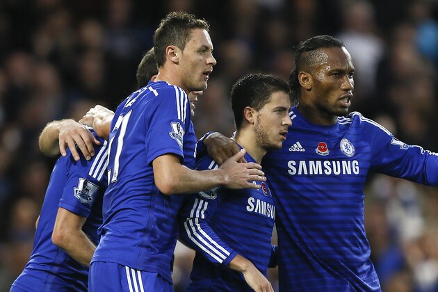 Chelsea's Eden Hazard, second right, celebrates with teammates after scoring a goal  during the English Premier League soccer match between Chelsea and Queens Park Rangers at Stamford Bridge Stadium in London, Saturday, Nov. 1, 2014. (AP Photo/Kirsty Wigglesworth)