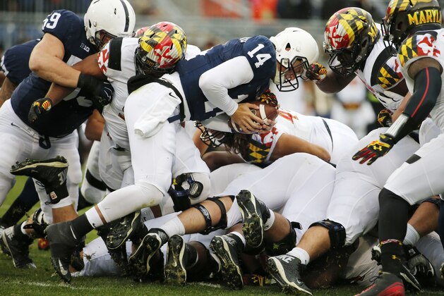 Penn State quarterback Christian Hackenberg (14) gets a first down on a quarterback sneak during the first quarter of an NCAA college football game against Maryland in State College, Pa., Saturday, Nov. 1, 2014. (AP Photo/Gene J. Puskar)
