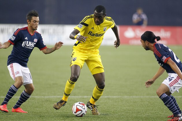 Columbus Crew's Tony Tchani (6) works with the ball between New England Revolution's Diego Fagundez, left, and Lee Nguyen (24) during the first half of an MLS soccer game, Saturday, July 26, 2014, in Foxborough, Mass. (AP Photo/Stew Milne)