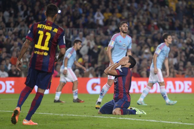 FC Barcelona's Luis Suarez, from Uruguay, center, reacts against Celta de Vigo during a Spanish La Liga soccer match at the Camp Nou stadium in Barcelona, Spain, Saturday, Nov. 1, 2014. (AP Photo/Manu Fernandez)