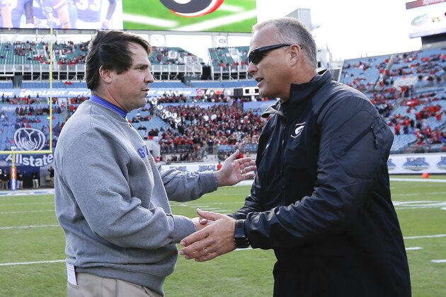 Florida head coach Will Muschamp left, and Georgia head coach Mark Richt, right, shake hands at midfield before the start of a NCAA college football game in Jacksonville, Fla., Saturday, Nov. 1, 2014. (AP Photo/Stephen B. Morton)