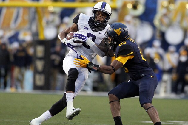 MORGANTOWN, WV - NOVEMBER 01:  Josh Doctson #9 of the TCU Horned Frogs makes a 10 yard catch against Terrell Chestnut #16 of the West Virginia Mountaineers in the third quarter during the game on November 1, 2014 at Mountaineer Field in Morgantown, West Virginia.  (Photo by Justin K. Aller/Getty Images)